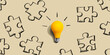 © Tierney - Jigsaw puzzle with a yellow light bulb - flat lay
