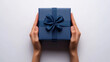 © Ashy studio - 3D female hands holding a gift box with ribbon bow aerial top view blue background. design for card present celebration birthday greeting material