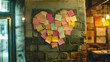 © GoldPumaze - Sticky notes arranged in a heart shape on a wall to promote positivity and motivation.