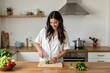 ©  S u n n y B u n n y - Woman preparing fresh ingredients in modern kitchen for healthy cooking