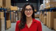© K silver - A confident professional woman smiles in a modern warehouse environment to showcase business success