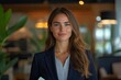 © SY - Smiling businesswoman in a suit. Perfect for promoting business success, corporate events, or professional services.