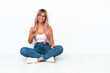 © luismolinero - Young mixed race woman with pink hair sitting on the floor isolated on white background shaking hands for closing a good deal