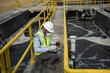 © VIEWFOTO STUDIO - Wastewater treatment concept. Service engineer on  waste water Treatment plant and checking oxygen in water with tablet.  Wastewater treatment concept. Service engineer on waste water Treatment plant.