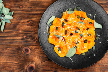 Canvas Print - Plate of pumpkin ravioli with sage leaves.