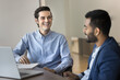 © fizkes - Cheerful successful Latin manager man talking to Indian colleague, business partner in office, discussing work collaboration, teamwork, successful startup project, smiling, laughing