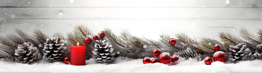Wall Mural - red christmas burning candles, balls, baubles and pine cones and branches in a row covered with snow