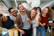 © NDABCREATIVITY - Happy multiracial group of business people having fun while celebrating on surprise party in office.