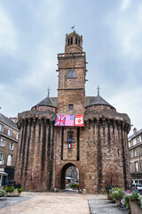 Wall Mural - Architecture of the clock tower in the town of Vire in Normandy in France with its church