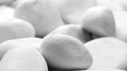 Aufkleber - A close up of white rocks with a greyish tint. The rocks are scattered and appear to be of various sizes. Concept of calmness and serenity
