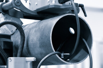 Aufkleber - A metal pipe is being worked on with a machine. The machine is black and silver