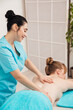 © dmitriisimakov - Spa masseur doing medical back massage to woman