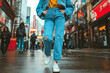 © tynza - Denim-on-denim outfit with a cropped jacket, high-waisted mom jeans, and chunky sneakers, styled in a vibrant city street.