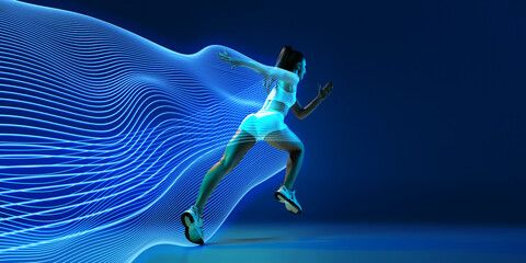 back view of athletic young woman in white sportswear in motion, running against blue background wit