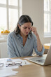© Derek Brumby - Stressed Young Woman Working from Home, Holding Head in Frustration