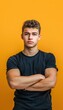 © Minerva Studio - Confident young man posing against orange background