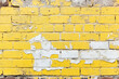 © Ivan - Textured yellow brick wall with peeling paint revealing white underneath in an urban setting during daylight hours. Generative AI