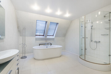 Wall Mural - A modern bright bathroom with windows over the bathtub and an oval glass shower cabin.