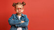 © Nick Alias - Adorable Little Girl with Pouty Expression, Red Glasses, and Denim Jacket Against Red Background