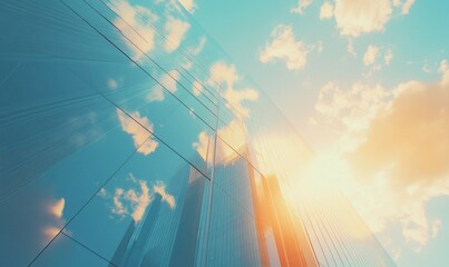 Wall Mural - low angle view of a modern glass building with the sun shining through the windows and reflecting th
