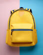 © Saddha Visual - Yellow backpack, School backpack, isolated on a Soft blue and Pink Pastel
