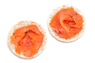 Wall Mural - Tasty Rice Cake Sandwiches with Fresh Salmon Slices Isolated on White - Top View. Easy Breakfast and Diet Food. Crispbread with Red Fish. Healthy Dietary Snacks - Isolation