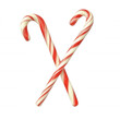 Festive red and white striped candy canes arranged in an X shape, isolated on white background, symbolizing holiday cheer and tradition.