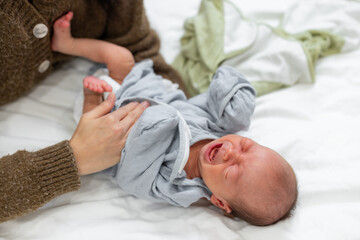 Canvas Print - Mother making tummy massage on her new born baby son