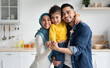 © Prostock-studio - Portrait Of Happy Muslim Family Of Three With little Daughter Posing In Kitchen, Cheerful Islamic Father, Child And Mother In Hijab Embracing And Smiling At Camera, Bonding At Home Together