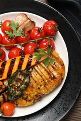 Wall Mural - Delicious grilled vegetables and chicken breast on wooden table, top view