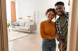 © Prostock-studio - Joyful African American Family Couple Embracing Standing In Opened Doors Of Their New Home, Smiling Looking At Camera. Housing For Married Couple. Real Estate Property Ownership Concept