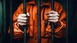 © Dee - Young adolescent imprisoned captured in confinement behind bars in orange jumpsuit in detention center