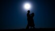 © WasinganAnwar - Silhouette of a couple dancing under the moonlight.