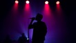 © WasinganAnwar - Silhouette of a singer performing on stage.