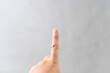 © koumaru - 白背景の前で人差し指を立てるイメージ