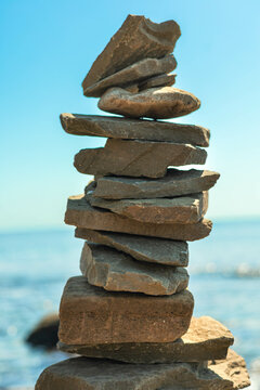 stone tower at sunny sea coast beach balance harmony zen symbol. natural pebble pyramid