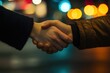 © AlAfiq - Hands Engaging in a Business Handshake at Night