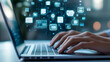 © Studios - Close-up of hands typing on a laptop with digital icons floating above A business person is using modern technology for online document management and data protection