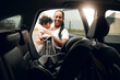 © peopleimages.com - Happy mother, car and baby with seat for road trip, travel and vehicle safety in city. Mom, child or kid with harness, belt or protection in security for transportation, journey or adventure together