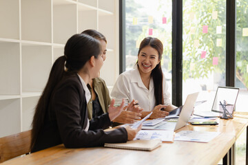 Wall Mural - Asian businesswoman teamwork working on laptop with finances analysis report at desk in office, business financing, accounting banking, Team of creative and business planning, 