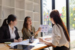 © SOMKID - Asian businesswoman teamwork working on laptop with finances analysis report at desk in office, business financing, accounting banking, Team of creative and business planning,