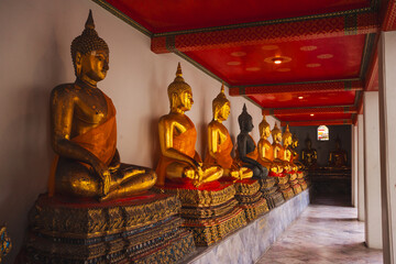 asia travel concept with golden buddha statue and old interior architecture at thailand temple