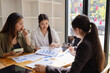 © SOMKID - Asian businesswoman teamwork working on laptop with finances analysis report at desk in office, business financing, accounting banking, Team of creative and business planning,
