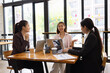 © SOMKID - Technology and financial advisory services concept. Businesswoman teamwork and working on digital laptop computer with advisor showing plan of investment to clients at table office. Digital marketing.