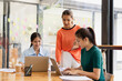 © SOMKID - Excited Asian businesswoman team working together in office, About successful startup projects concept.