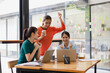 © SOMKID - Excited Asian businesswoman team working together in office, About successful startup projects concept.