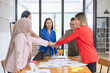 © SOMKID - Asian business teamwork making handshake with partner in meeting room, Greeting and corporate business handshake, 