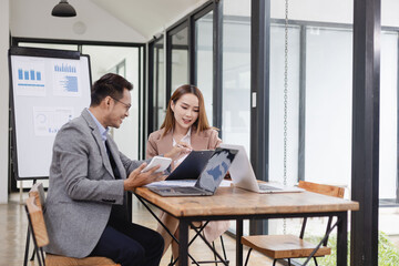 Wall Mural - Two business people working with business financing accounting banking and laptop with finances analysis report at desk in office. 