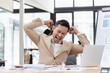 © SOMKID - Businessman stressed working with laptop on desk in office.