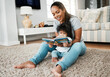 © peopleimages.com - Happy mother, baby and reading with book on floor for story, bonding or early childhood development at home. Mom, child or kid with smile for novel, learning or education in living room at house
